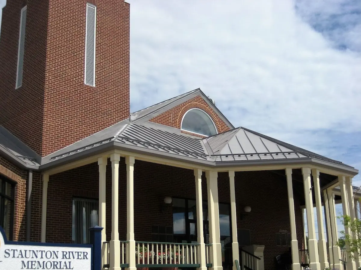 Skilled roofing craftsmen working on a residential roof in American Village